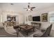 Open-concept living room featuring neutral tones, a ceiling fan, and seamless transition to the dining area at 240 N Monterey Ct, Casa Grande, AZ 85194