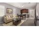 Cozy living room with neutral walls, ceiling fan, and access to a kitchenette, ideal for entertaining at 240 N Monterey Ct, Casa Grande, AZ 85194