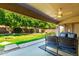 Spacious backyard with lush green grass, mature trees, and patio at 2698 E Carla Vista Dr, Gilbert, AZ 85295