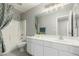 Bathroom with white cabinets, large mirror, and shower at 2698 E Carla Vista Dr, Gilbert, AZ 85295