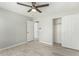Bedroom features a ceiling fan, tiled floors, a closet, and entrance door at 2698 E Carla Vista Dr, Gilbert, AZ 85295