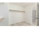 Neutral colored walk-in closet features a rod and access to bathroom at 2698 E Carla Vista Dr, Gilbert, AZ 85295