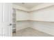 Large walk-in closet with shelves and rods and door to the bedroom at 2698 E Carla Vista Dr, Gilbert, AZ 85295