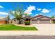 Charming single-story home with a well-manicured lawn, mature trees, and a spacious three-car garage at 2698 E Carla Vista Dr, Gilbert, AZ 85295