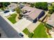 Aerial view of a home with a three car garage, extended drive, xeriscaping and mature landscaping at 2698 E Carla Vista Dr, Gilbert, AZ 85295