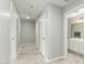 Hallway with white walls, tile floors, and access to bathroom at 2698 E Carla Vista Dr, Gilbert, AZ 85295
