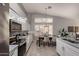 Eat-in kitchen features white cabinets, mosaic backsplash, granite countertops and stainless steel appliances at 2698 E Carla Vista Dr, Gilbert, AZ 85295