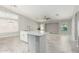 Bright kitchen featuring an island with marble countertop, sink, and tile floors at 2698 E Carla Vista Dr, Gilbert, AZ 85295