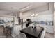 Open-concept kitchen featuring white cabinets, stainless steel appliances, dining area, and stylish backsplash at 2698 E Carla Vista Dr, Gilbert, AZ 85295