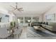 Staged living room featuring ample seating, a dining table and modern decor in a spacious, sunlit room at 2698 E Carla Vista Dr, Gilbert, AZ 85295