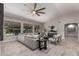 Open living room with large windows, a ceiling fan, and comfortable seating arrangement at 2698 E Carla Vista Dr, Gilbert, AZ 85295