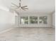 Expansive living room with large windows showcasing the backyard, tile floors, and a ceiling fan at 2698 E Carla Vista Dr, Gilbert, AZ 85295