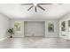 Bright living room with beautiful tile floors, neutral walls, and large windows offering serene backyard views at 2698 E Carla Vista Dr, Gilbert, AZ 85295