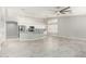 Bright living area seamlessly connects to the kitchen, featuring neutral paint, tile flooring, and modern lighting at 2698 E Carla Vista Dr, Gilbert, AZ 85295