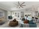 Staged living room with modern furnishings, tile floors, open to the kitchen with island at 2698 E Carla Vista Dr, Gilbert, AZ 85295
