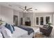 Bright main bedroom with a sitting area, ceiling fan, neutral decor, and private backyard access at 2698 E Carla Vista Dr, Gilbert, AZ 85295