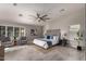 Spacious main bedroom featuring a ceiling fan, neutral decor, and plush seating area with natural lighting at 2698 E Carla Vista Dr, Gilbert, AZ 85295