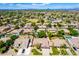 Aerial view of a neighborhood with lush landscaping and mountain views at 2698 E Carla Vista Dr, Gilbert, AZ 85295