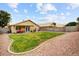 Large backyard featuring a green lawn, gravel landscaping, and a block fence at 2727 S Sawyer Cir, Mesa, AZ 85209