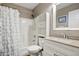 Bright bathroom featuring a shower over tub, white vanity, and built-in shelving for storage at 2727 S Sawyer Cir, Mesa, AZ 85209