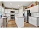 Well-lit kitchen with white cabinets, stainless steel appliances, and a center island at 2727 S Sawyer Cir, Mesa, AZ 85209