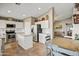 Spacious eat-in kitchen featuring white cabinets, stainless steel appliances, and tile backsplash at 2727 S Sawyer Cir, Mesa, AZ 85209