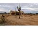 New construction: a single-Gathering home is being framed on a vast lot in Arizona, partially covered with protective material at 28668 N 151St Ave, Surprise, AZ 85387