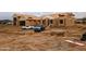 New construction: a large, single-Gathering home is being framed on a vast lot in Arizona, partially covered with protective material at 28668 N 151St Ave, Surprise, AZ 85387