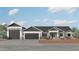 Charming single-story home with a three-car garage, desert landscaping, and modern architectural details at 28668 N 151St Ave, Surprise, AZ 85387