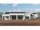A modern home's rear exterior, featuring a large patio and contemporary architectural features at 28668 N 151St Ave, Surprise, AZ 85387