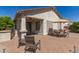 Back patio seating area with brick pavers, a built-in grill, and a patio dining set at 289 W Ironhorse Ln, San Tan Valley, AZ 85143