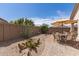 Charming backyard patio with desert landscaping, covered seating area and privacy walls at 289 W Ironhorse Ln, San Tan Valley, AZ 85143