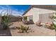 Desert landscaped backyard featuring an outdoor kitchen, patio seating, and cacti at 289 W Ironhorse Ln, San Tan Valley, AZ 85143