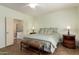 Primary bedroom featuring a comfortable bed, bench, and adjoining bathroom at 289 W Ironhorse Ln, San Tan Valley, AZ 85143