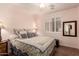 Comfortable bedroom featuring soft lighting, neutral tones, and tiled floors at 289 W Ironhorse Ln, San Tan Valley, AZ 85143