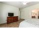 Comfortable bedroom with ensuite bathroom and a TV hanging on the wall at 289 W Ironhorse Ln, San Tan Valley, AZ 85143