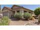 Front of a house with desert landscaping including yucca and cacti, as well as a covered entryway at 289 W Ironhorse Ln, San Tan Valley, AZ 85143