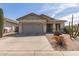 Charming single-story home featuring a low-maintenance desert landscaped front yard and attached two-car garage at 289 W Ironhorse Ln, San Tan Valley, AZ 85143