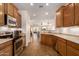 A kitchen with oak cabinetry, stainless steel appliances, and an open floor plan at 289 W Ironhorse Ln, San Tan Valley, AZ 85143