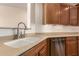 Stainless steel dishwasher and a double bowl sink complement the oak kitchen cabinetry at 289 W Ironhorse Ln, San Tan Valley, AZ 85143