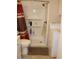 Practical bathroom features a shower, a washing machine, and shelves for organized storage in a compact space at 303 S Recker Rd # 218, Mesa, AZ 85206