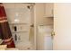 Functional bathroom with a shower, laundry machine and built-in shelves for storage and convenience at 303 S Recker Rd # 218, Mesa, AZ 85206