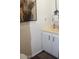 Bathroom featuring a sink, vanity, light fixture, and an interesting painting at 303 S Recker Rd # 218, Mesa, AZ 85206