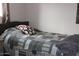 Bedroom with a bed and decorative pillow and patterned quilt at 303 S Recker Rd # 218, Mesa, AZ 85206