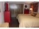 Comfortable bedroom with a soft bed, a red dresser, and ample closet space for a restful retreat at 303 S Recker Rd # 218, Mesa, AZ 85206