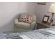 Bedroom featuring a cozy chair with a patterned pillow and a side table with a lamp at 303 S Recker Rd # 218, Mesa, AZ 85206