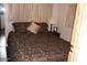 Comfortable bedroom showcasing a patterned bedspread and a bedside table with a lamp at 303 S Recker Rd # 218, Mesa, AZ 85206