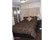 Bedroom with a patterned bedspread and built-in wardrobes with drawers and cabinets at 303 S Recker Rd # 218, Mesa, AZ 85206
