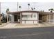 Charming home with a covered carport, mature landscaping, and sidewalk access at 303 S Recker Rd # 218, Mesa, AZ 85206