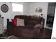 A welcoming living room with a cozy sofa, a decorative clock, and a stylish entertainment center at 303 S Recker Rd # 218, Mesa, AZ 85206